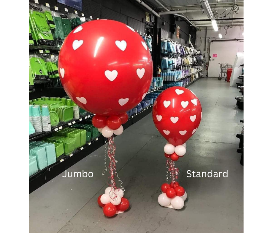 Two red balloons with white hearts on them are in a store.