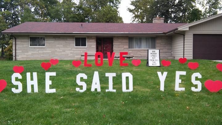 A sign in front of a house that says she said yes