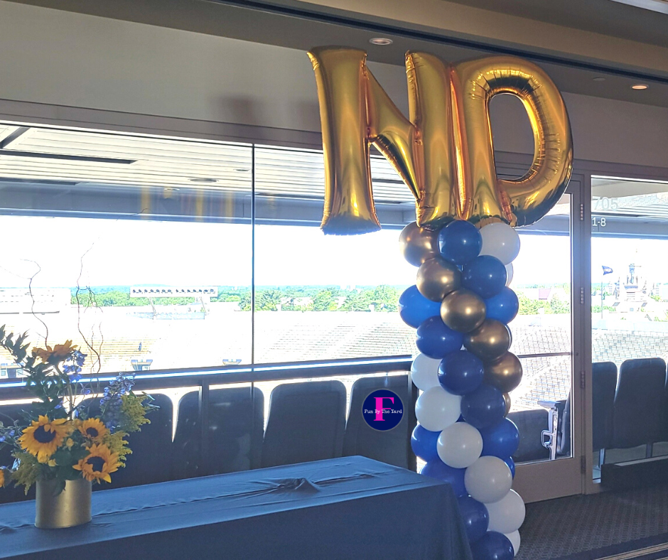 a balloon shaped like the letter np hangs from the ceiling