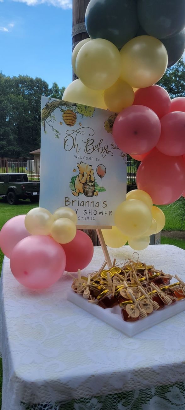 A table decorated with balloons and food for a baby shower.