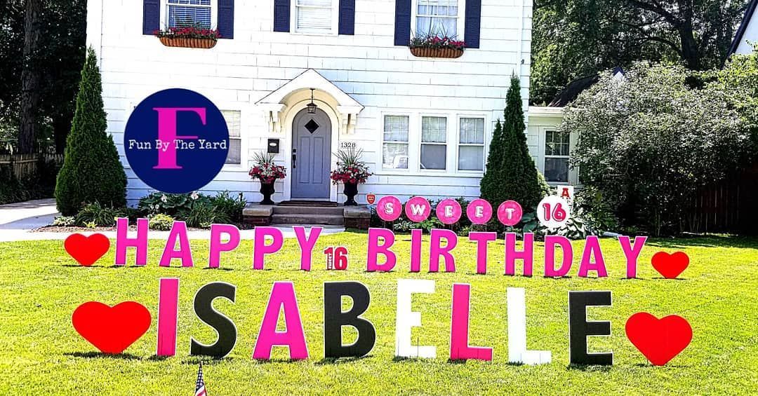 A house with a happy birthday sign in front of it.