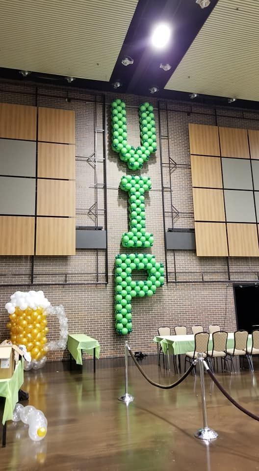 The word vip is made out of balloons in a room.