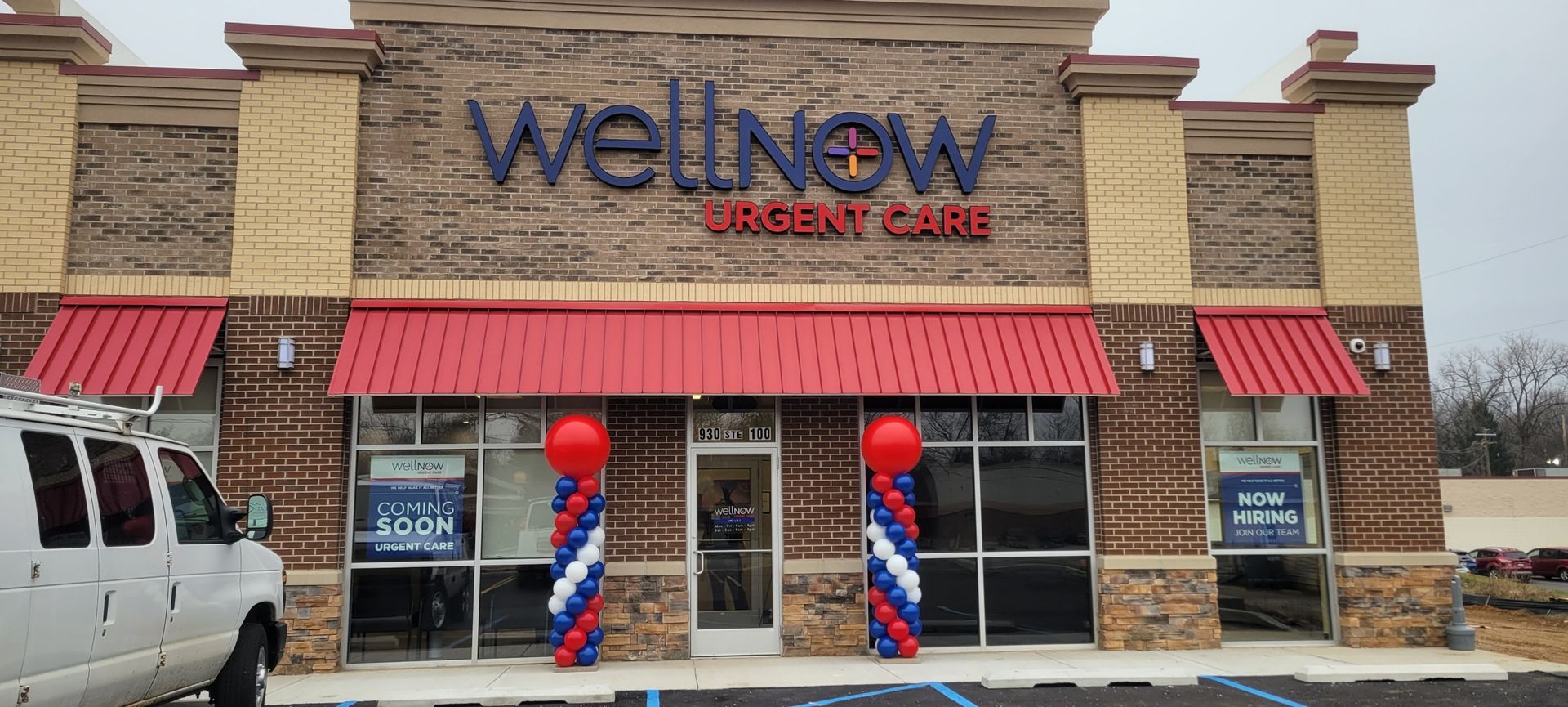 A wellnow urgent care store with balloons in front of it.