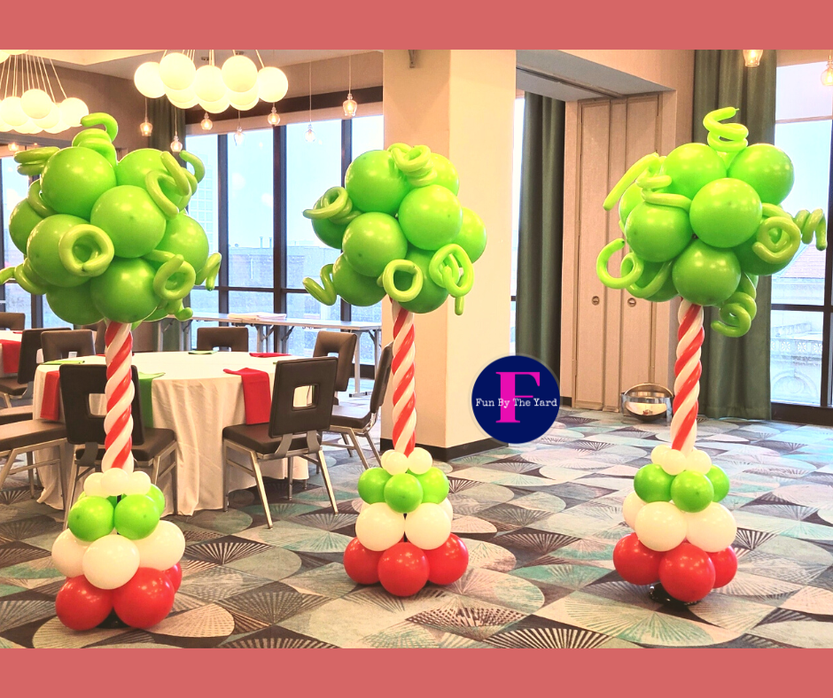 A room decorated with balloons in the shape of trees and candy canes. Dr. Suess