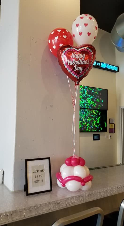 A bunch of balloons are sitting on top of a table.