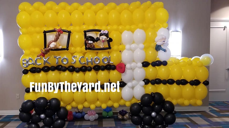 A school bus made out of balloons with the words back to school written on it