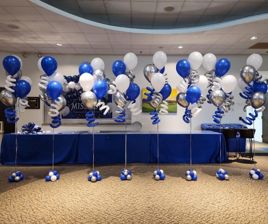 A room filled with blue white and silver balloons