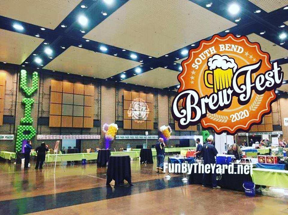 A large room with tables and a sign that says south bend brew fest