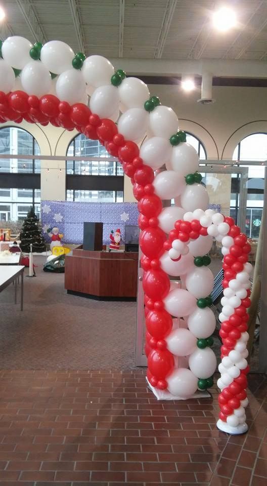 A candy cane made out of red and white balloons