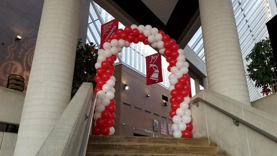 Stairs leading up to a building with a red and white balloon arch