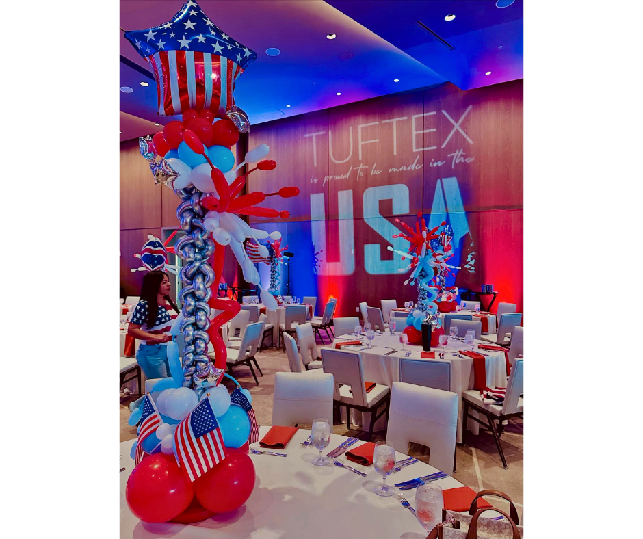 Festive USA-themed event with balloon decorations and tables set for a gathering. Red, white, and blue colors.
