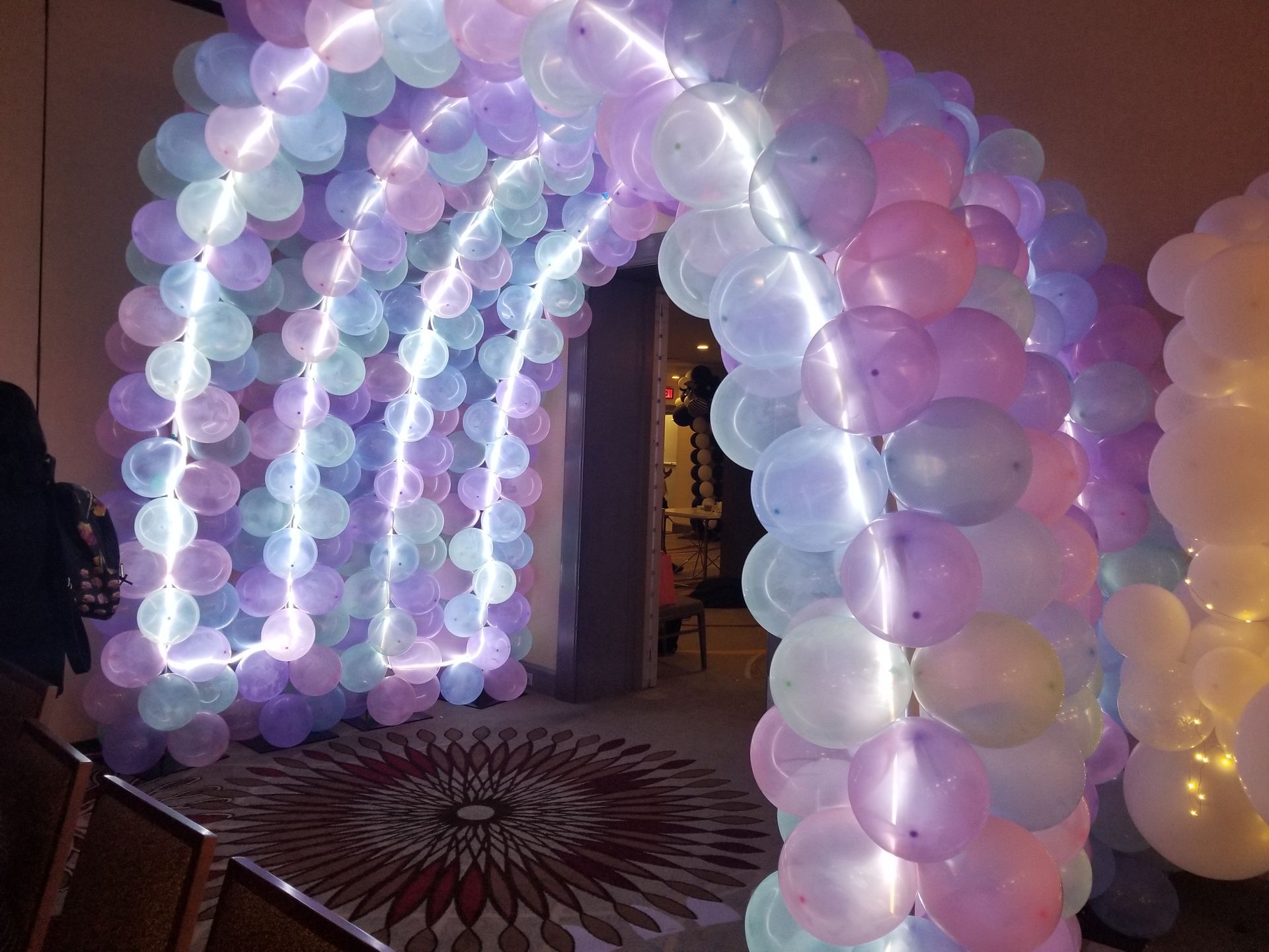 A room filled with balloons and lights.