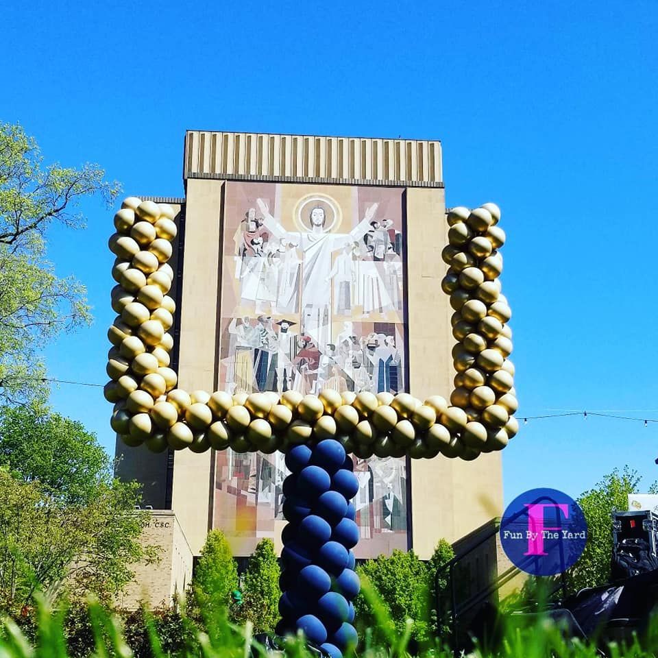 A balloon football goal post made of balloons in front of Touch Down Jesus at the University of Notre Dame