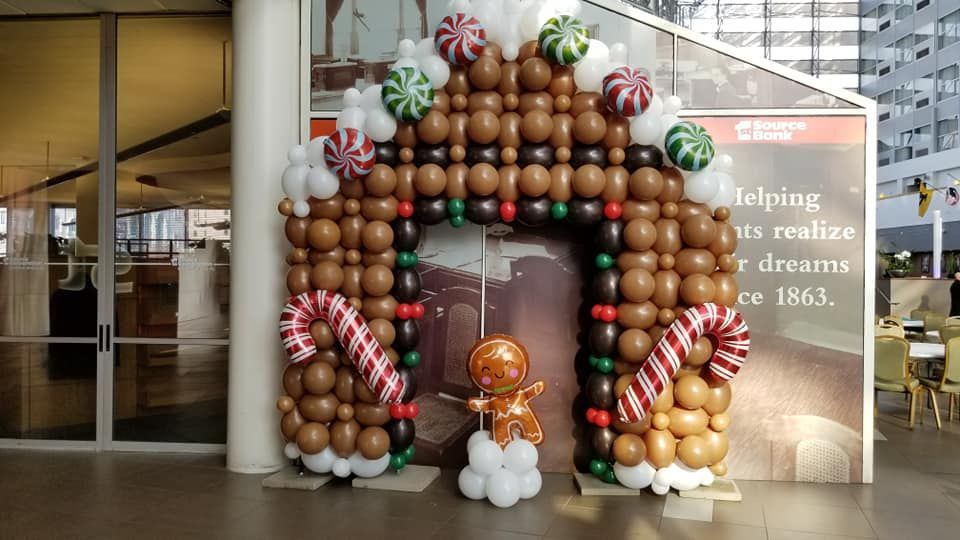 A gingerbread house made out of balloons and candy canes.