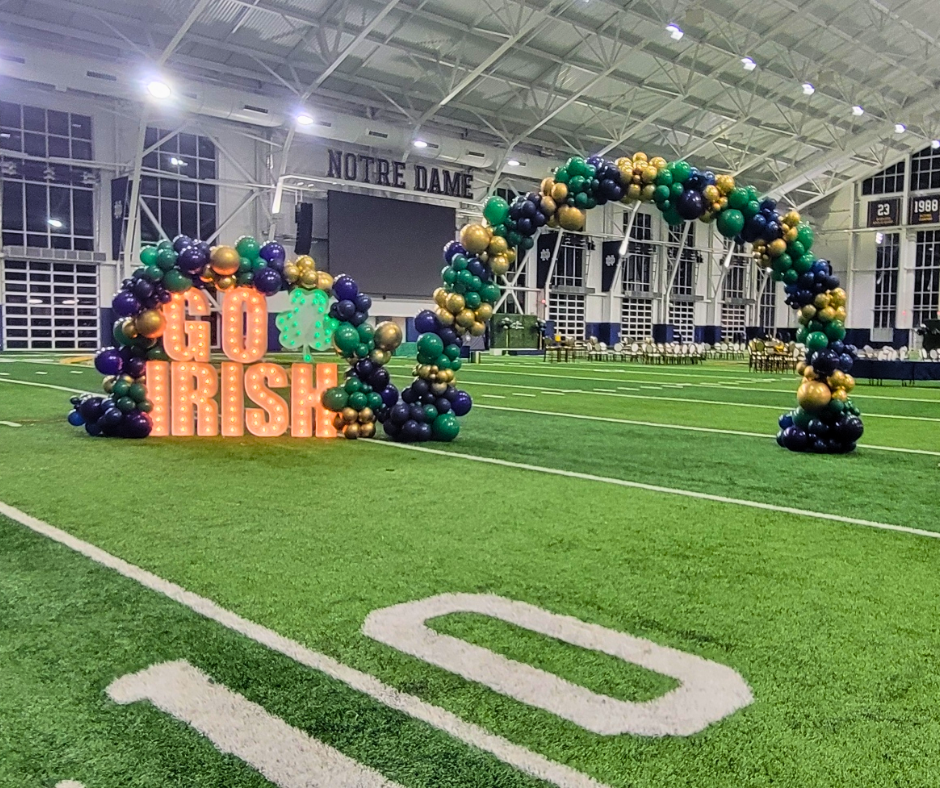 A football field with balloons and a sign that says go irish