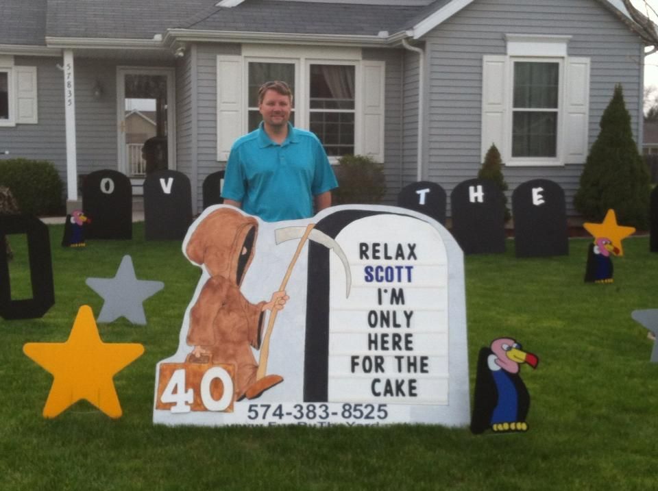 A man stands in front of a sign that says