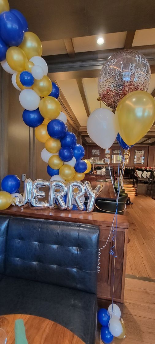 a restaurant is decorated with balloons and a sign that says jerry