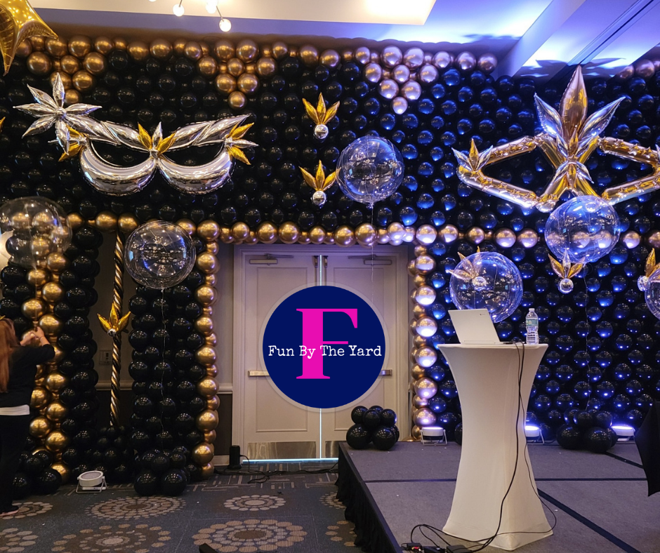 A room filled with balloons and a sign that says i 'm by the yard