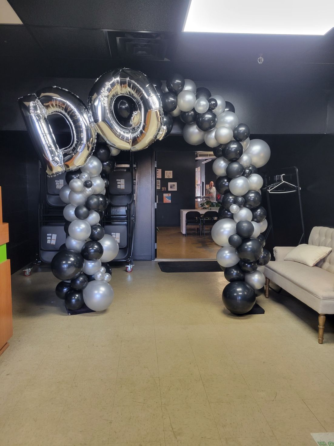 A room with a balloon arch and a couch