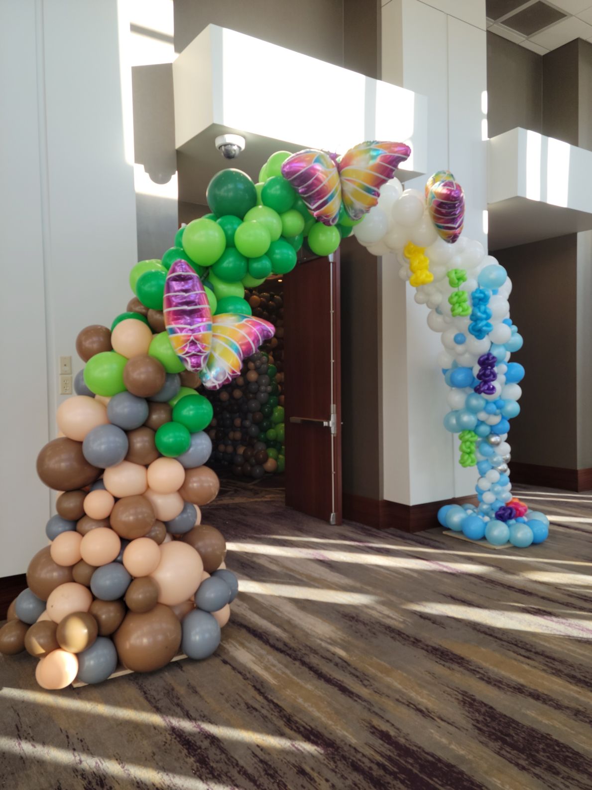 A large arch made of balloons in a room