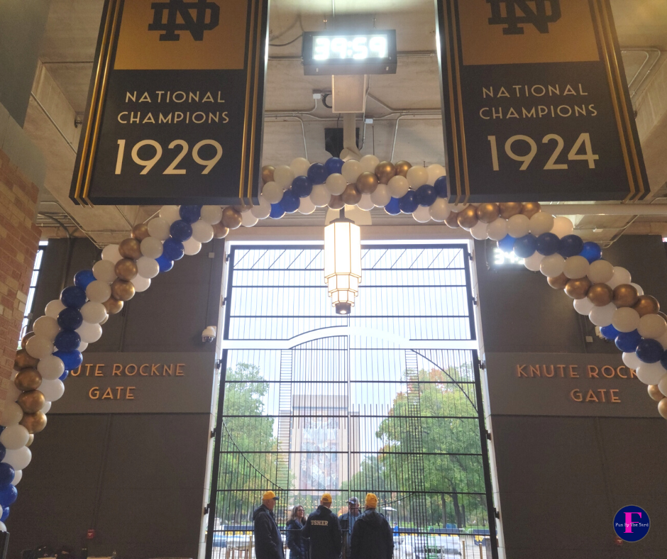 A sign that says national champions 1924 on it with a balloon arch in blue white and gold