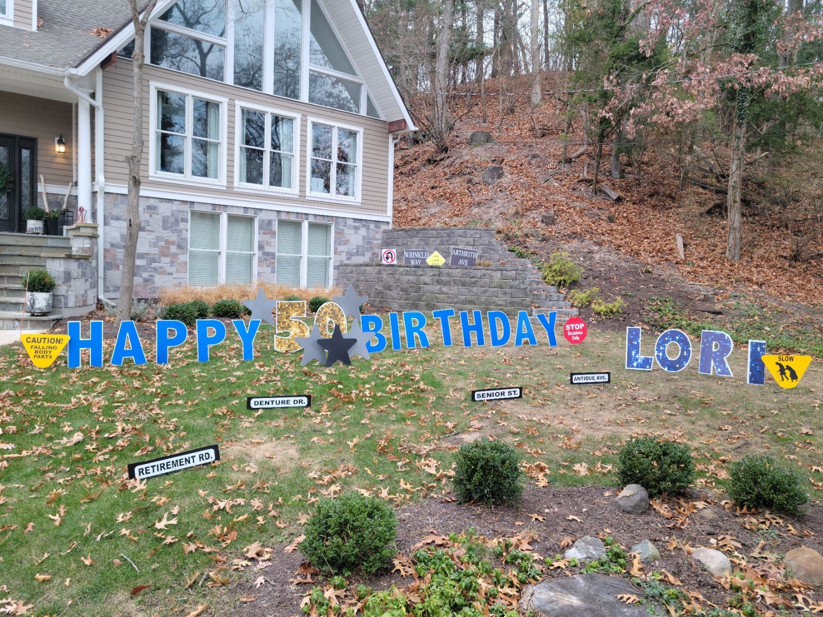 A house with a happy birthday sign in front of it.