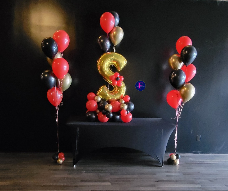 Balloon arrangement with red, black, and gold balloons; a gold
