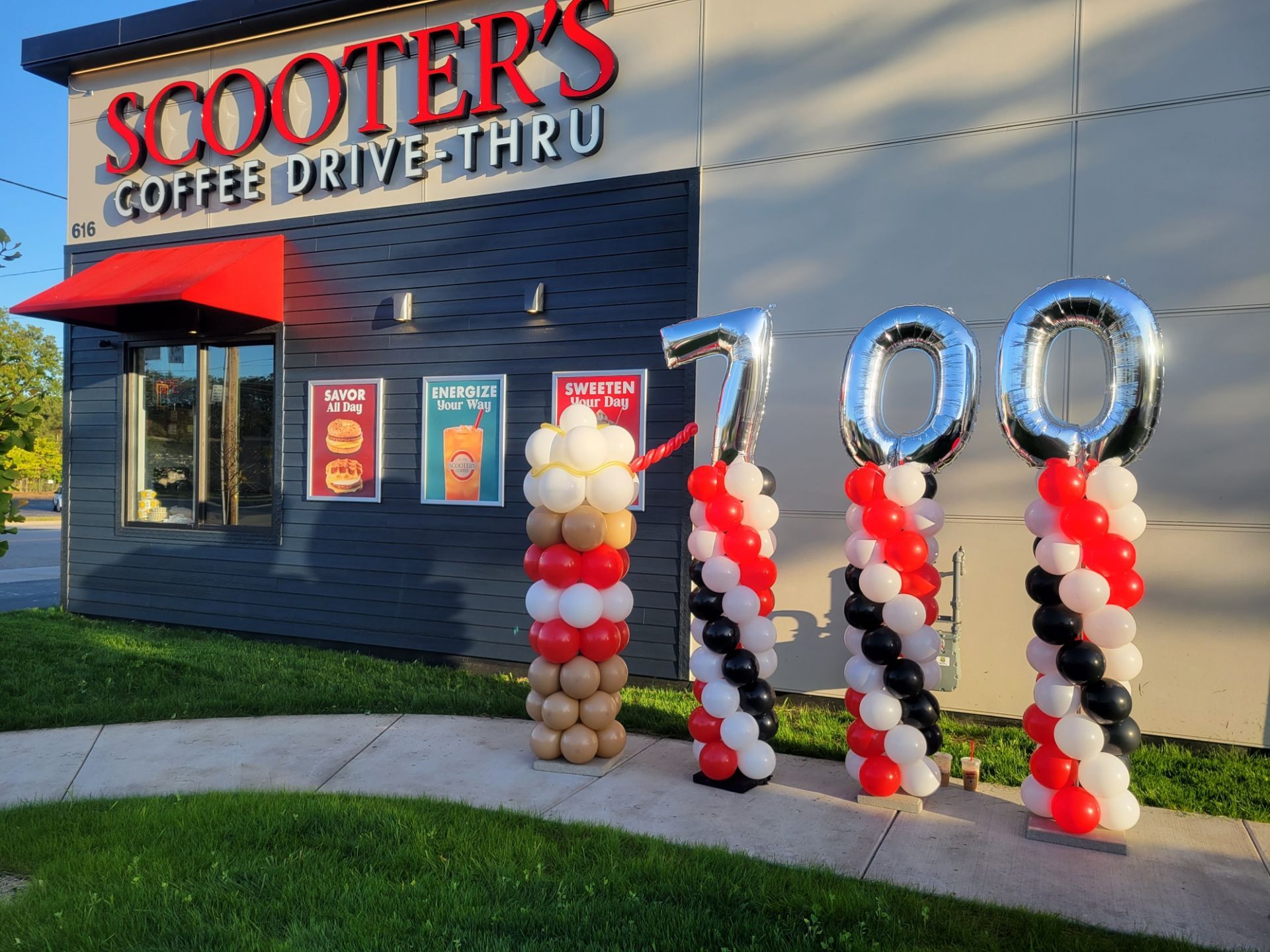 Scooter 's coffee drive thru is celebrating its 100th anniversary with balloon columns and a coffee drink