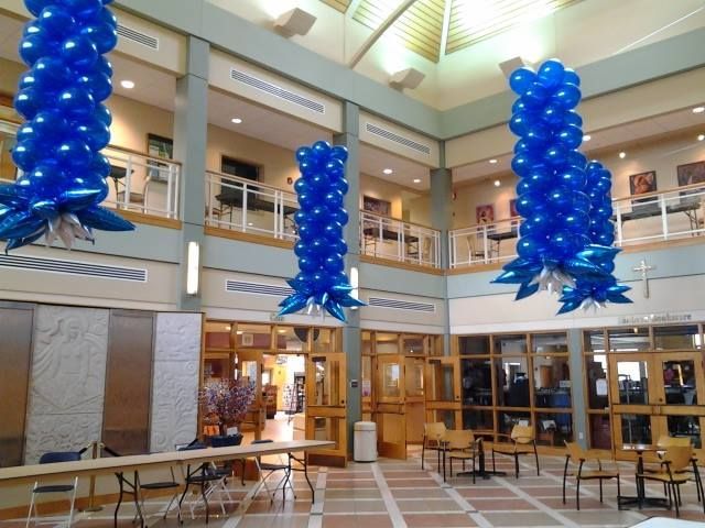 A large room with blue balloons hanging from the ceiling