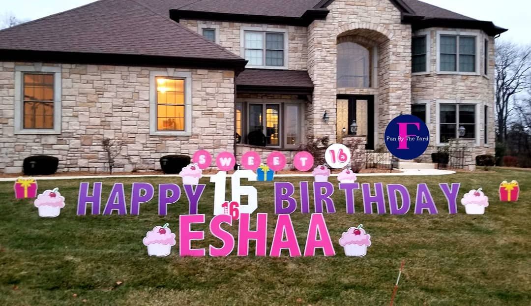 A house with a happy 16th birthday sign in front of it.