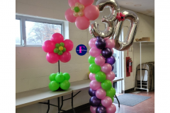 A room filled with balloons and a number 30 balloon.