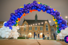 A large arch free form organic arch in rainbow colors for St. Patrick's Day at Notre Dame