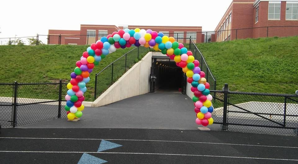 Colorful balloon archway over a tunnel entrance at a St. Joe High school.