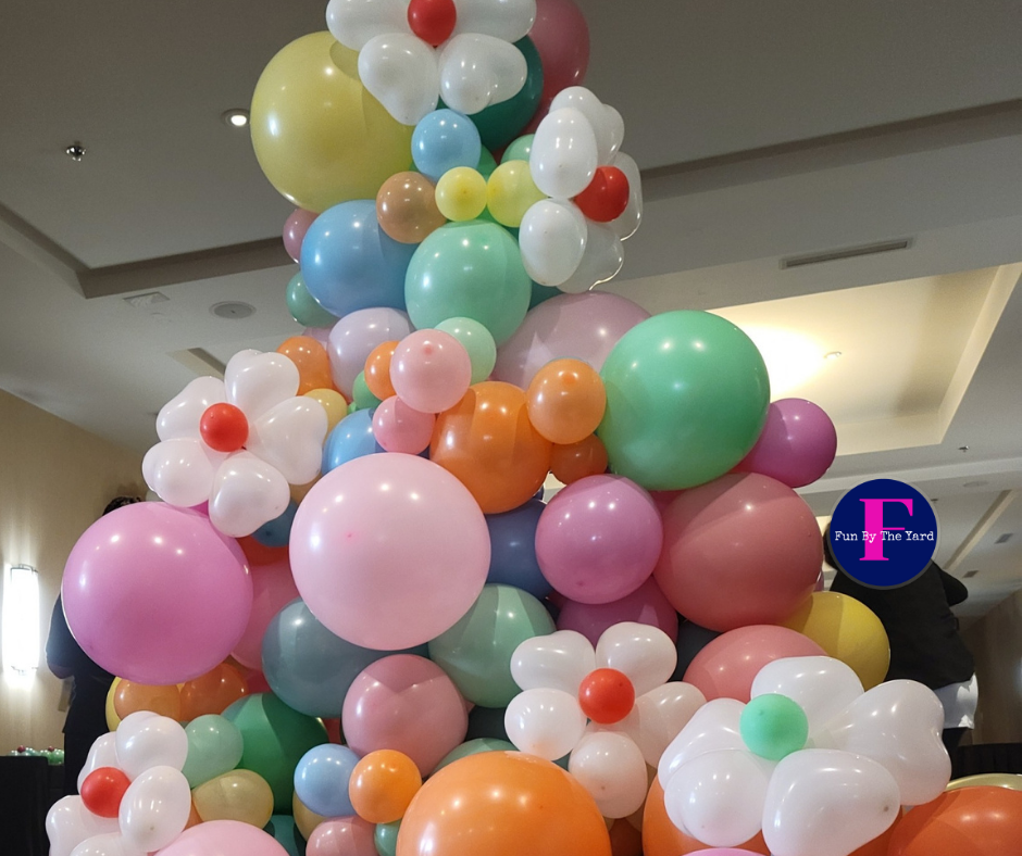 A bunch of colorful balloons are stacked on top of each other