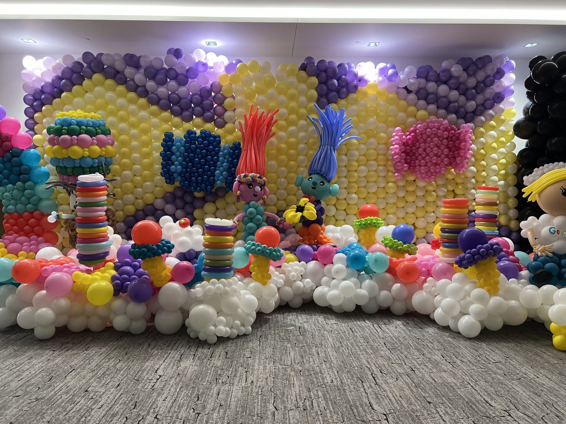 A room filled with lots of colorful balloons and decorations.