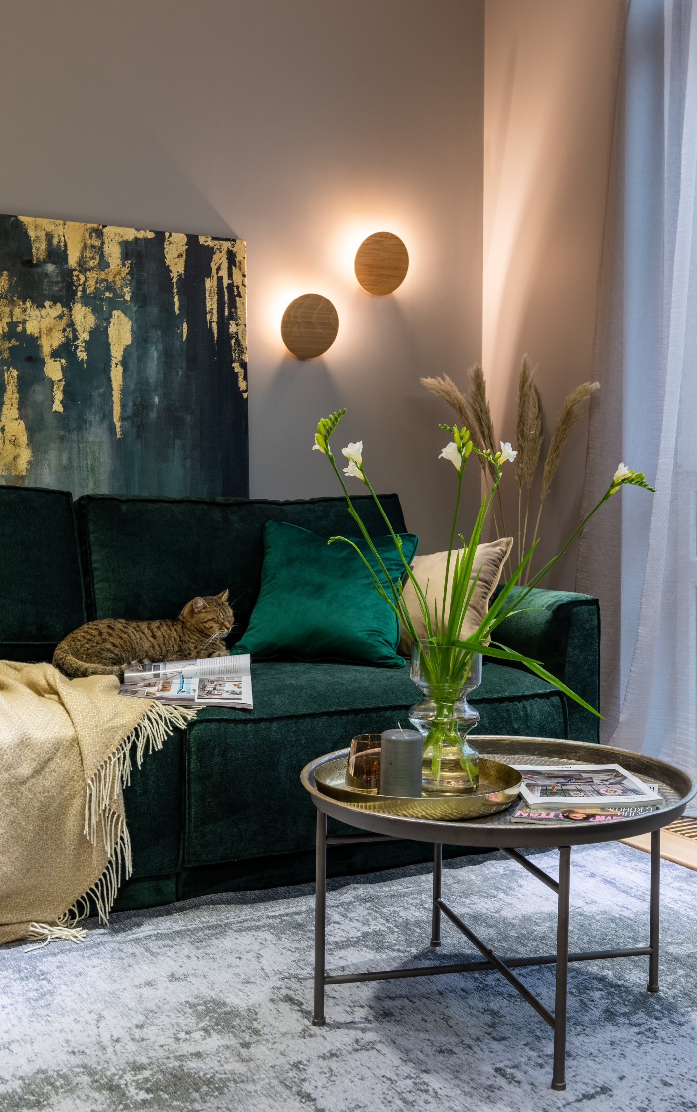 A living room with a green couch and a coffee table.