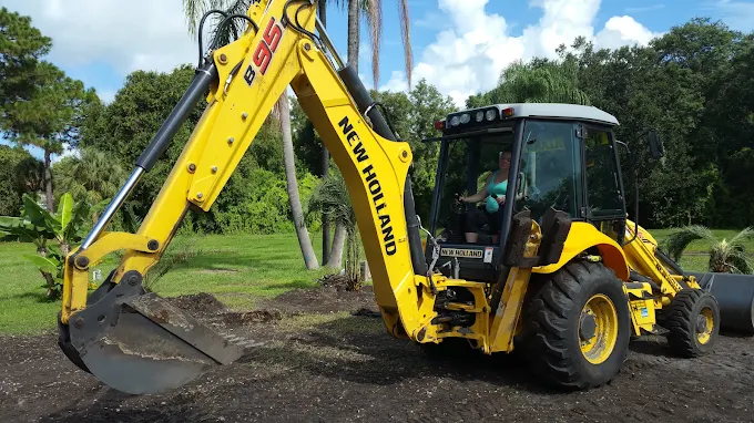 A yellow tractor with the word new holland on it