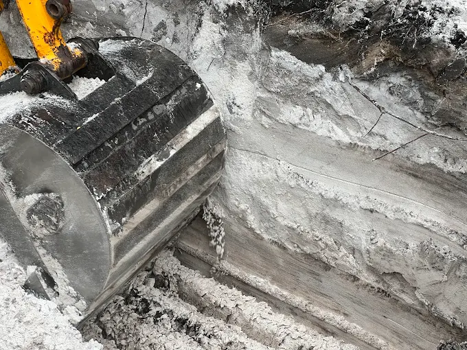 A bulldozer is digging a hole in the ground.