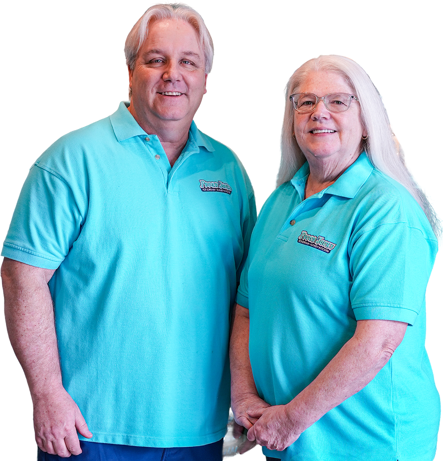 A man and a woman standing next to each other wearing blue shirts