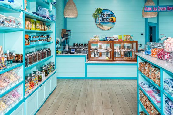 A candy store with lots of shelves and jars of candy.