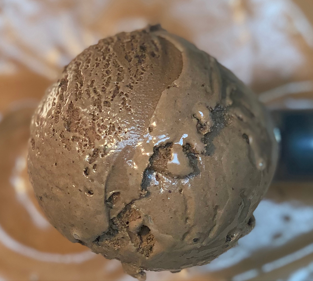 A close up of a scoop of chocolate ice cream
