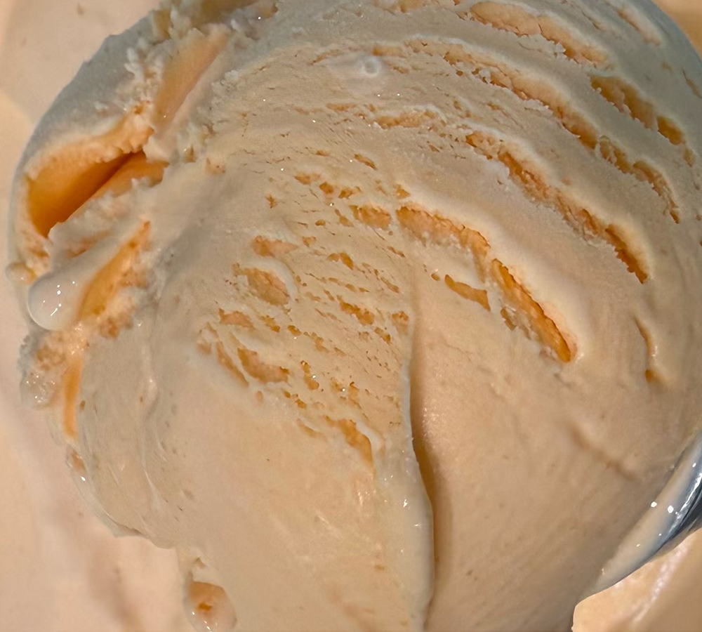 A close up of a scoop of ice cream on a plate