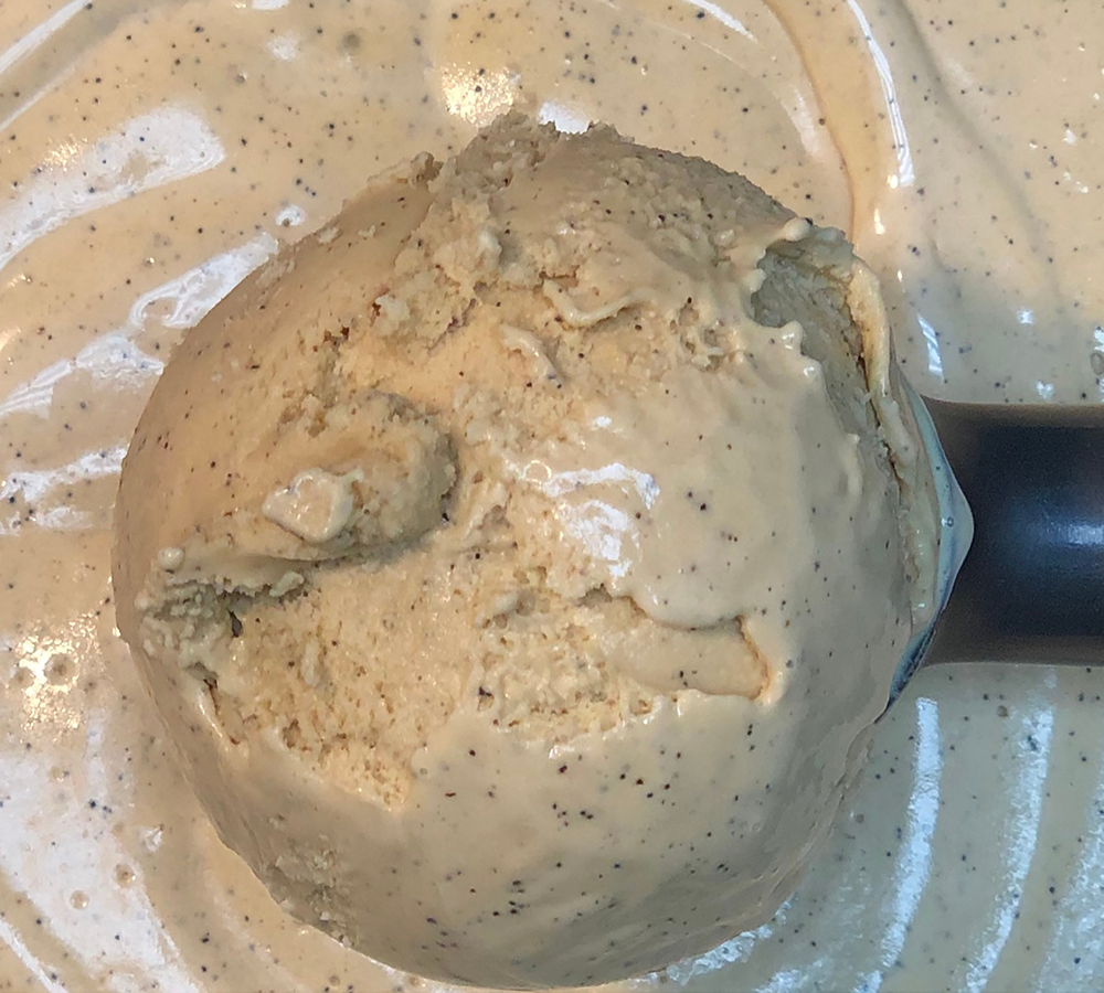 A close up of a scoop of ice cream on a plate