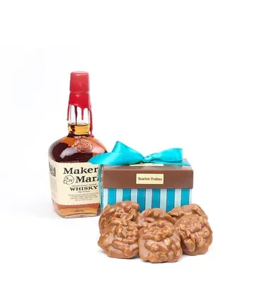 A bottle of maker 's mark whiskey next to a box of pecan pie cookies.