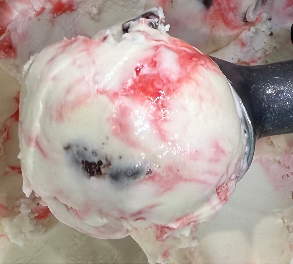 A close up of a waffle cone filled with ice cream.