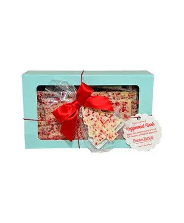 A box of peppermint bark with a red bow.