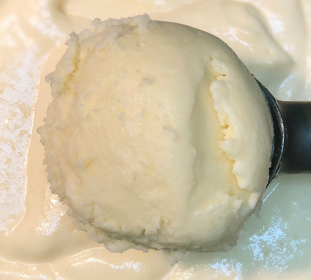 A close up of a scoop of ice cream on a plate
