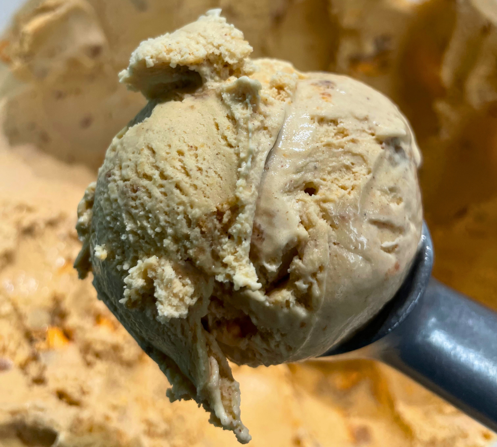 A close up of a scoop of ice cream on a table