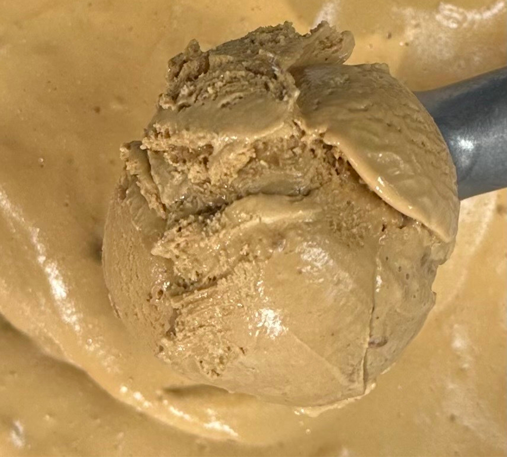 A close up of a scoop of ice cream on a plate