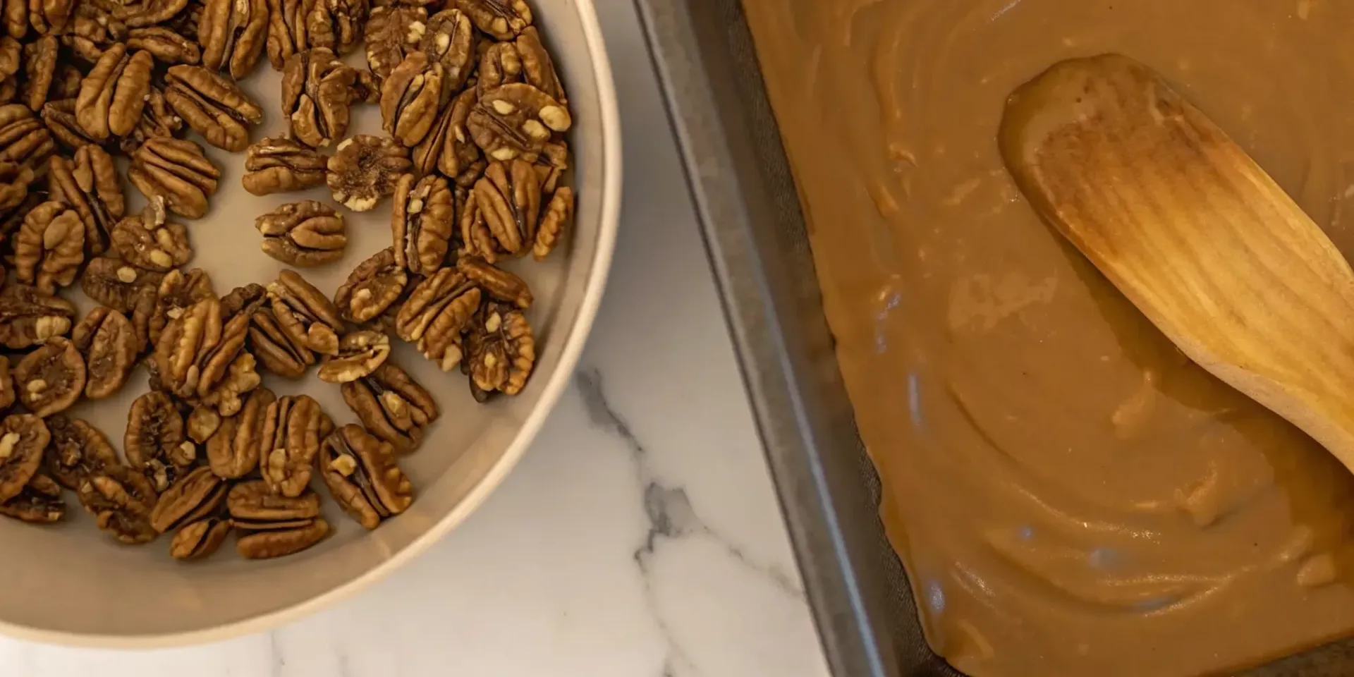 Fresh pecans and a creamy mixture being stirred for authentic southern candymakers pralines.
